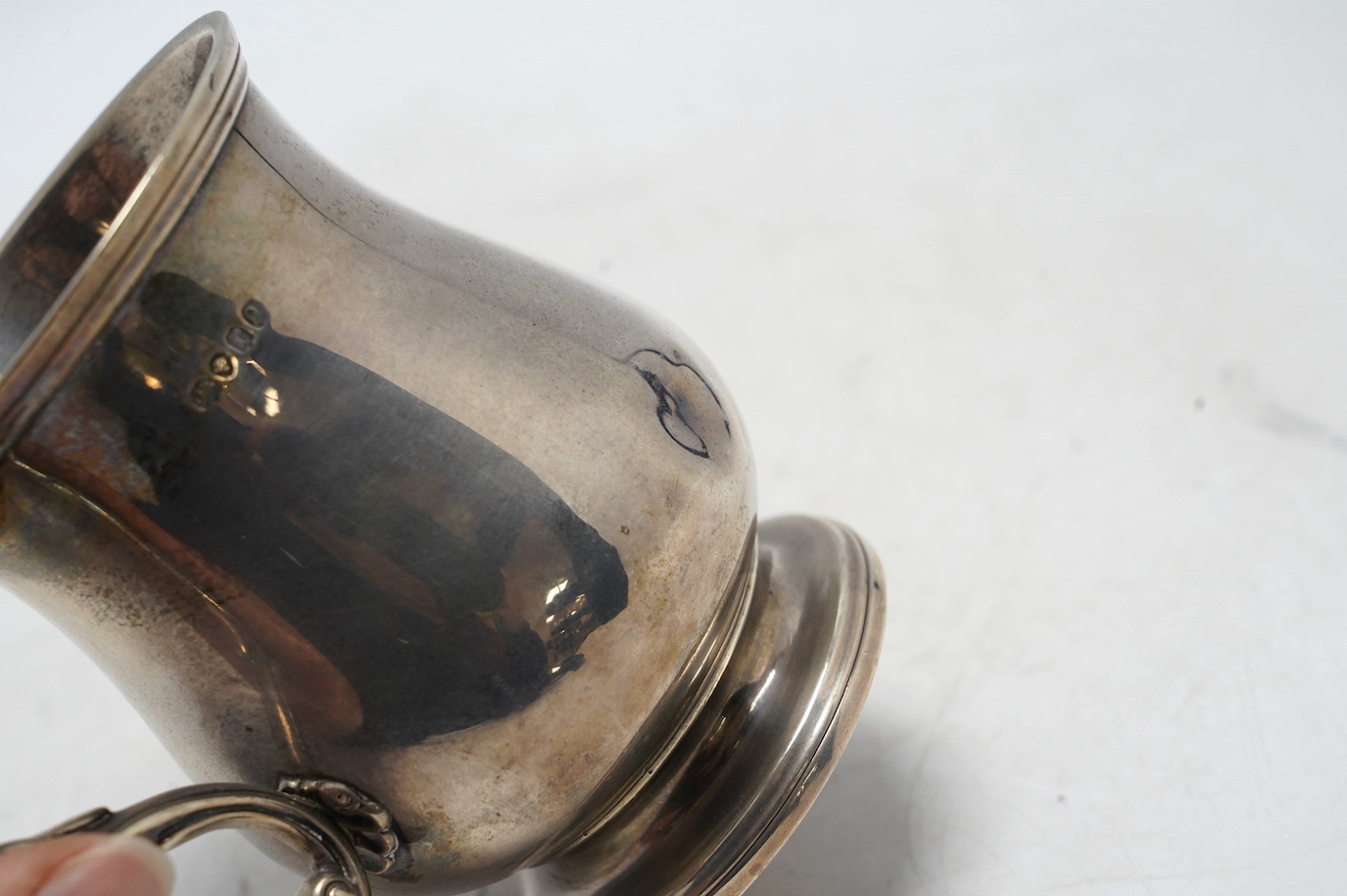 A William IV silver baluster christening mug, maker's mark rubbed, London, 1832, 11.8cm, 7.5oz, with later engraved inscription. Condition - poor